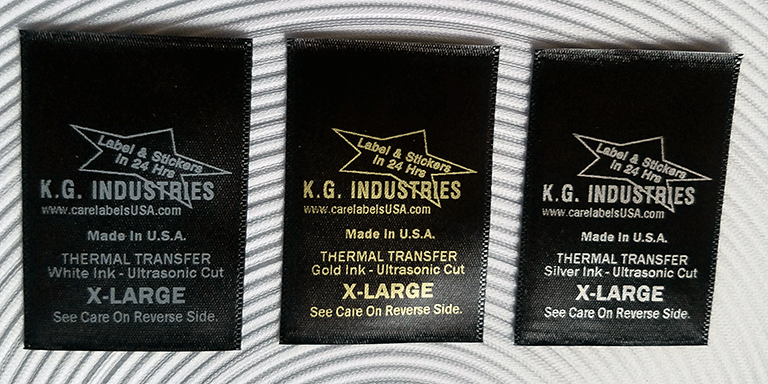 Black woven edge satin wash care label. Ribon ink colors white gold and silver. All satin labels are cut with ultrasonic knife for fray-proof soft edges suitable for skin contact.